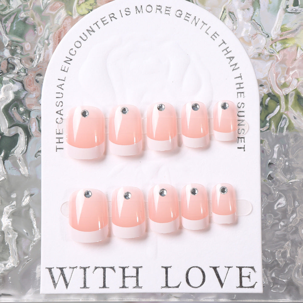 Set of pink and white nail art tips on packaging in close-up view 