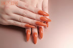 Hand with orange nail polish on a white background