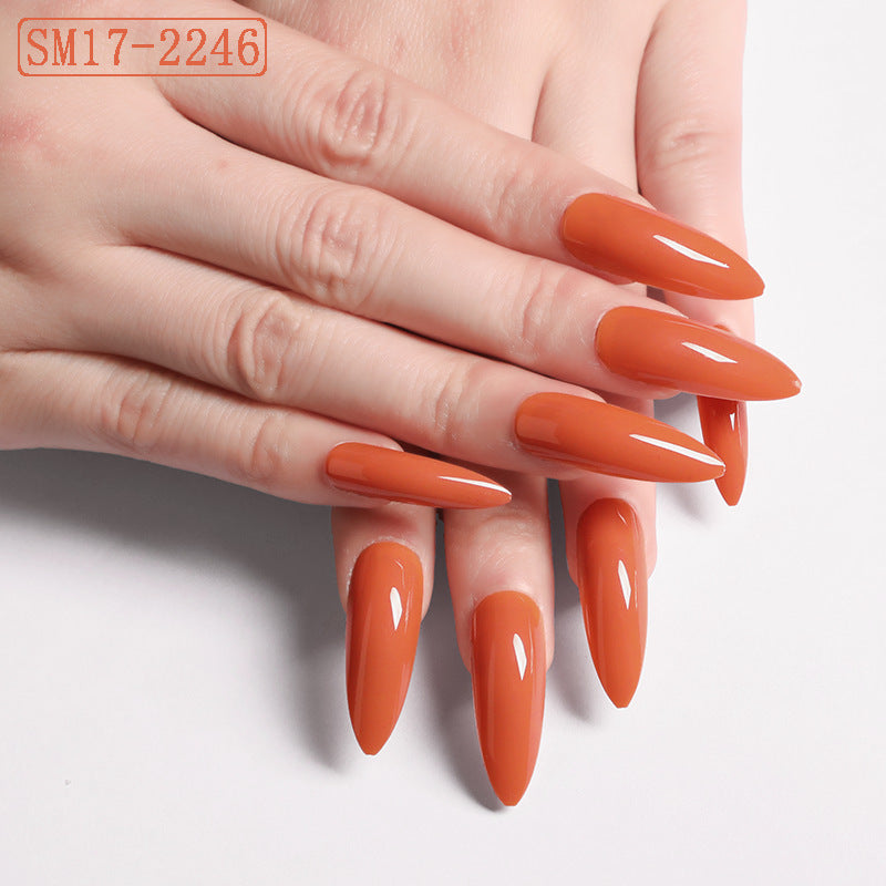 Hand with orange nail polish on a white background