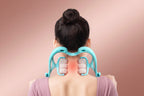 Person using a turquoise neck and shoulder massager on a white background