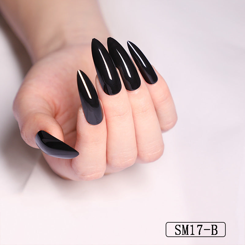 Hand with black nail polish on a plain background