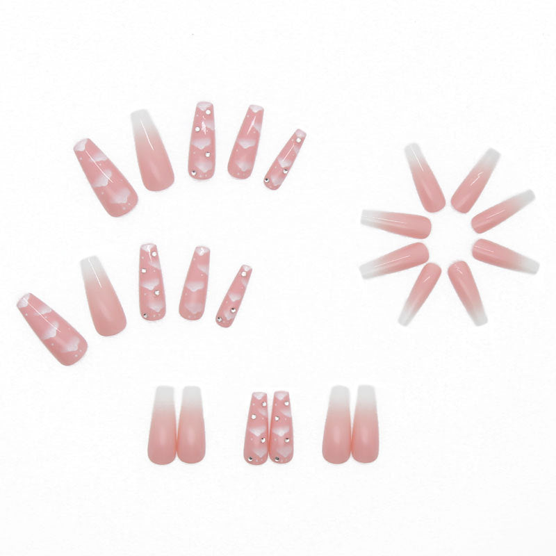 "Close-up view of pink cloud nails in press-on set."
