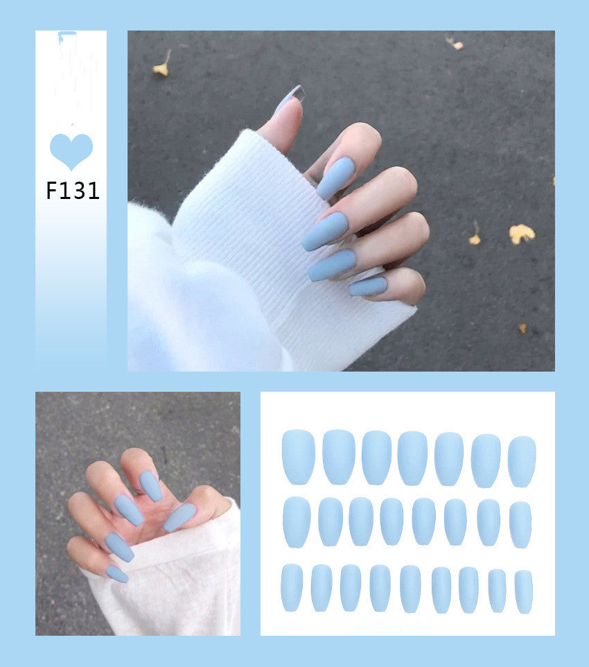 A collection of false nails in a light blue color, displayed on a model hand 