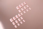 Set of pink nail extensions on a white background