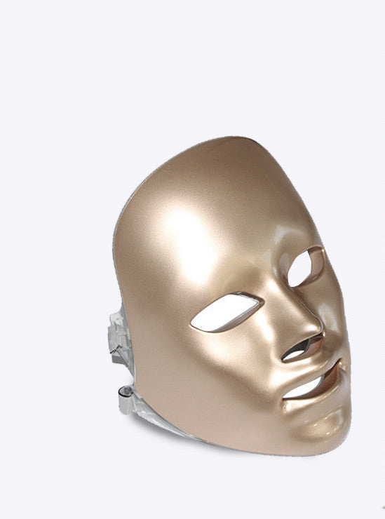 Gold facial mask on a white background