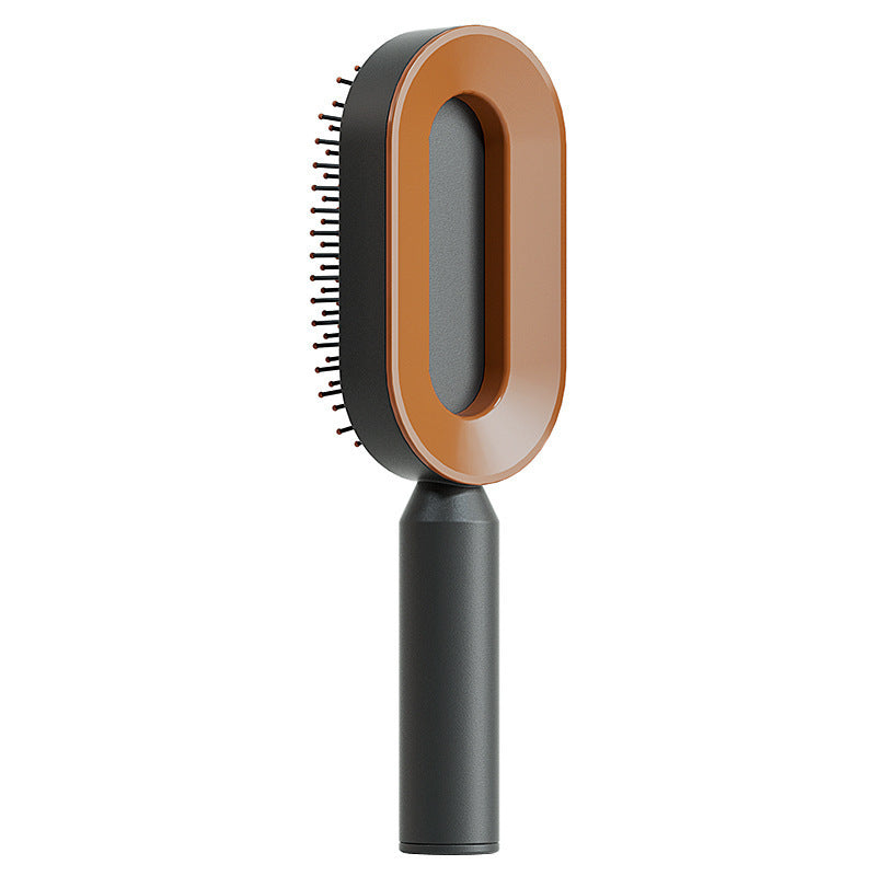 Hairbrush with brown bristle head and black handle on a white background