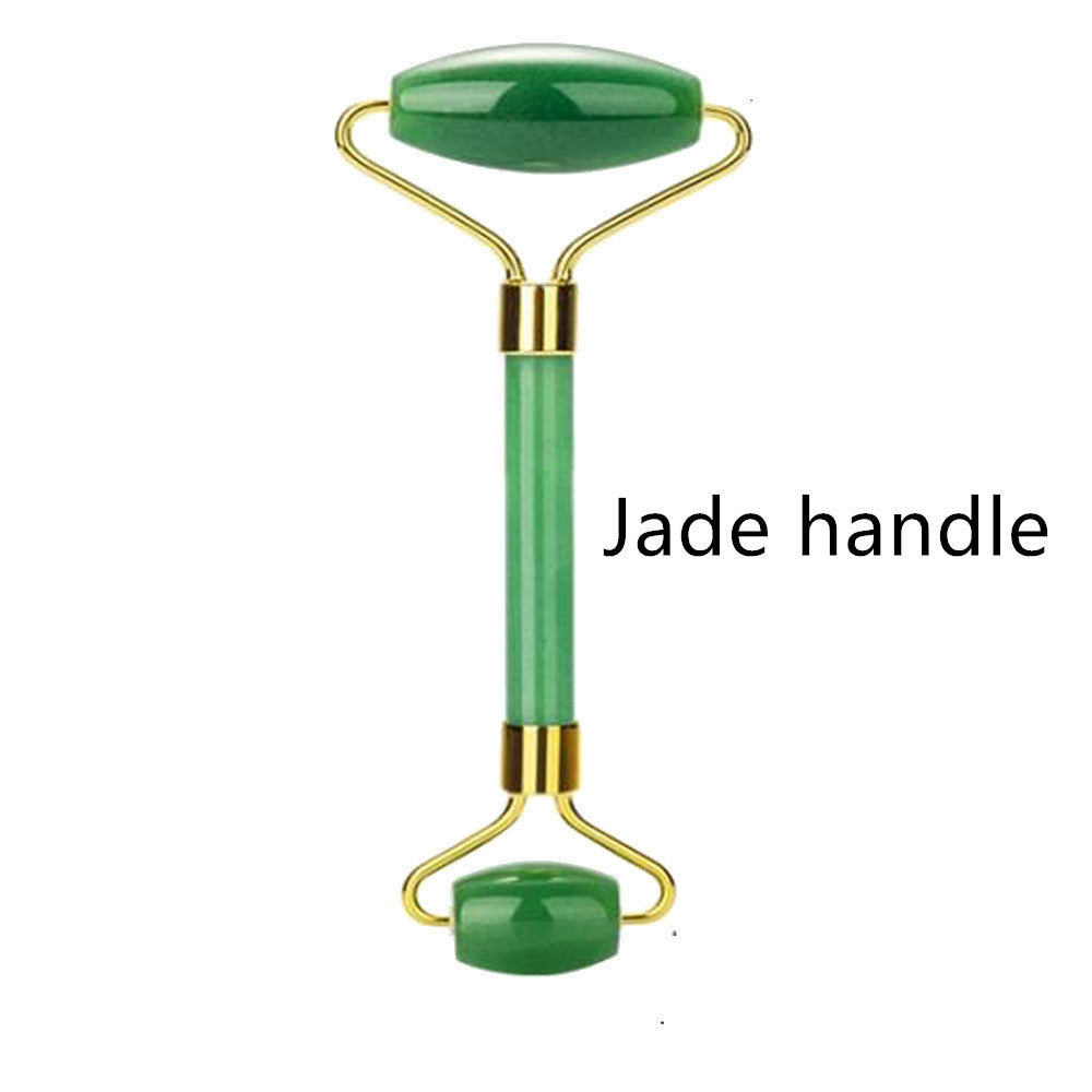 Jade facial roller with gold accents on a white background