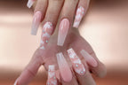 A set of false nails with a pink cloud design and rhinestone embellishments.