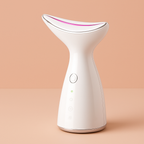 White facial wrinkles tighten skin tool with a pink light on a beige background