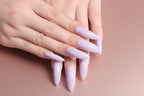 Hand with lavender acrylic nails on a white background