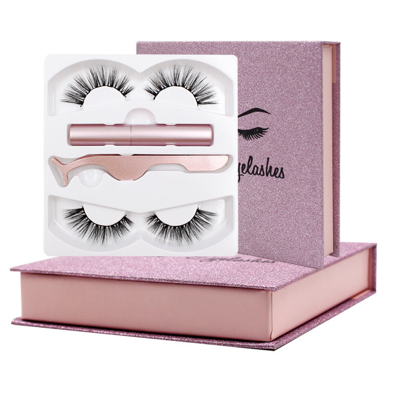 A set of magnetic eyelashes presented in a pink box with a pair of scissors and a tube of magnetic eyeliner, alongside two trays containing false eyelashes.