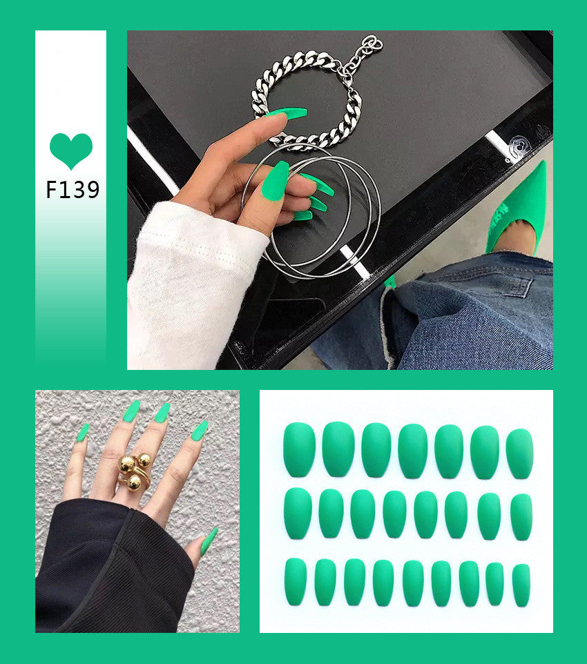 Mint green press-on nails set close-up view on model finger 