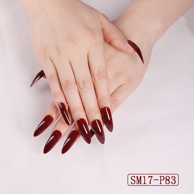 Close-up of hands with dark red nail polish on a light background