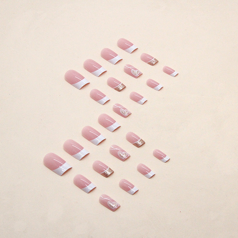 "Pink heart press-on nails set arranged by size and shape."
