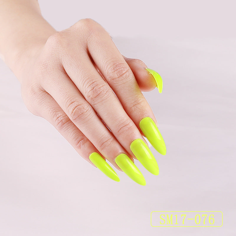Hand with neon green nails on a light gray background