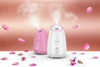 Two humidifiers, one pink and one white, with 'moer' branding, against a soft pink rose background.