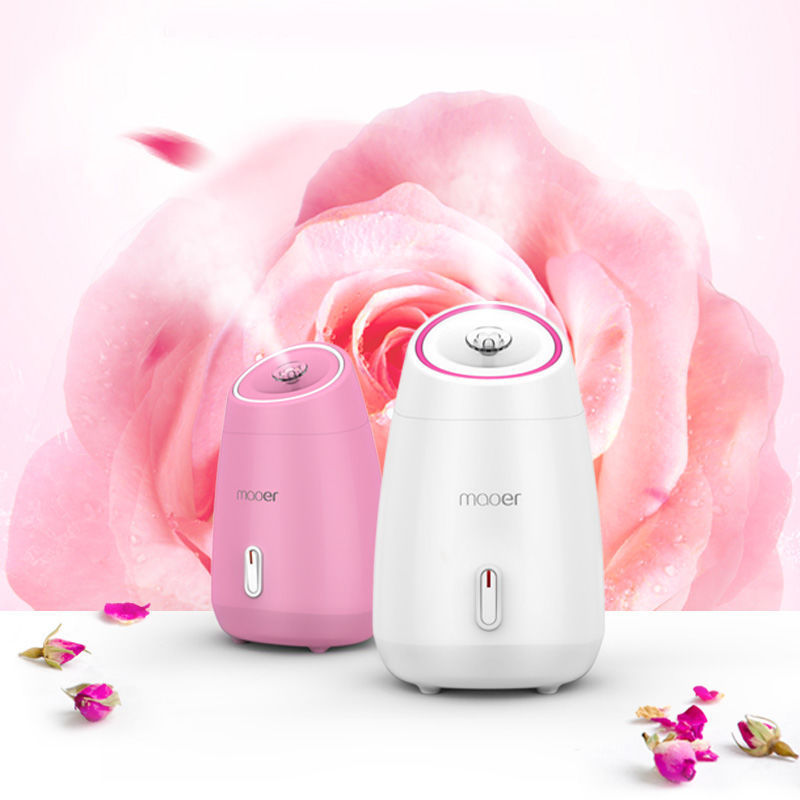 Two humidifiers, one pink and one white, with 'moer' branding, against a soft pink rose background.