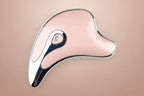 Pink and black Gua Sha tool on a white background