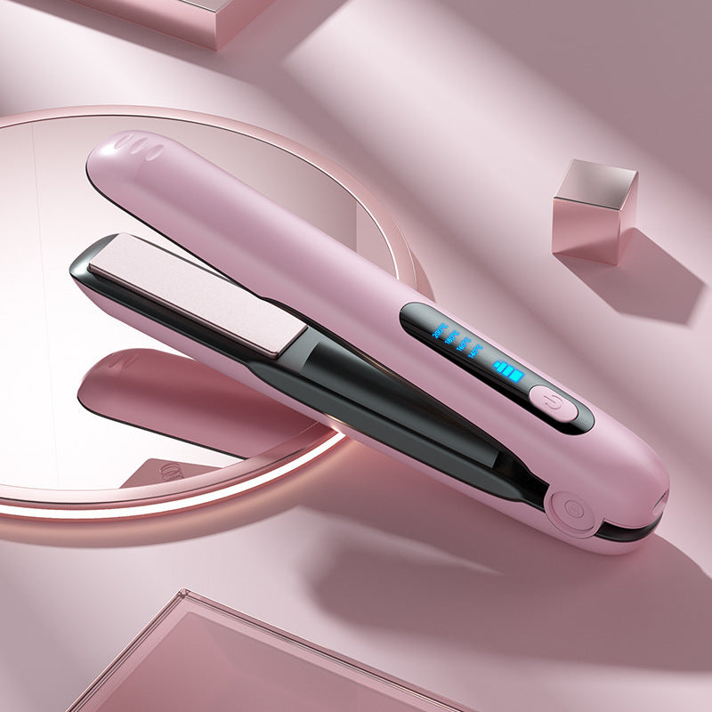 Pink hair straightener with digital display on a pink background