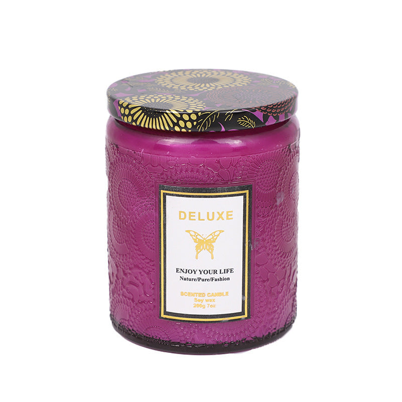 Purple candle with decorative lid on a white background
