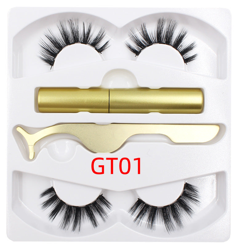 A set of magnetic eyelashes presented in a pink box with a pair of scissors and a tube of magnetic eyeliner, alongside two trays containing false eyelashes.