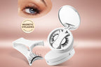 A white pod containing magnetic eyelashes with individual lash strips displayed in a circular arrangement. Includes an applicator tool and a pair of eyes with eyelashes applied to demonstrate usage.