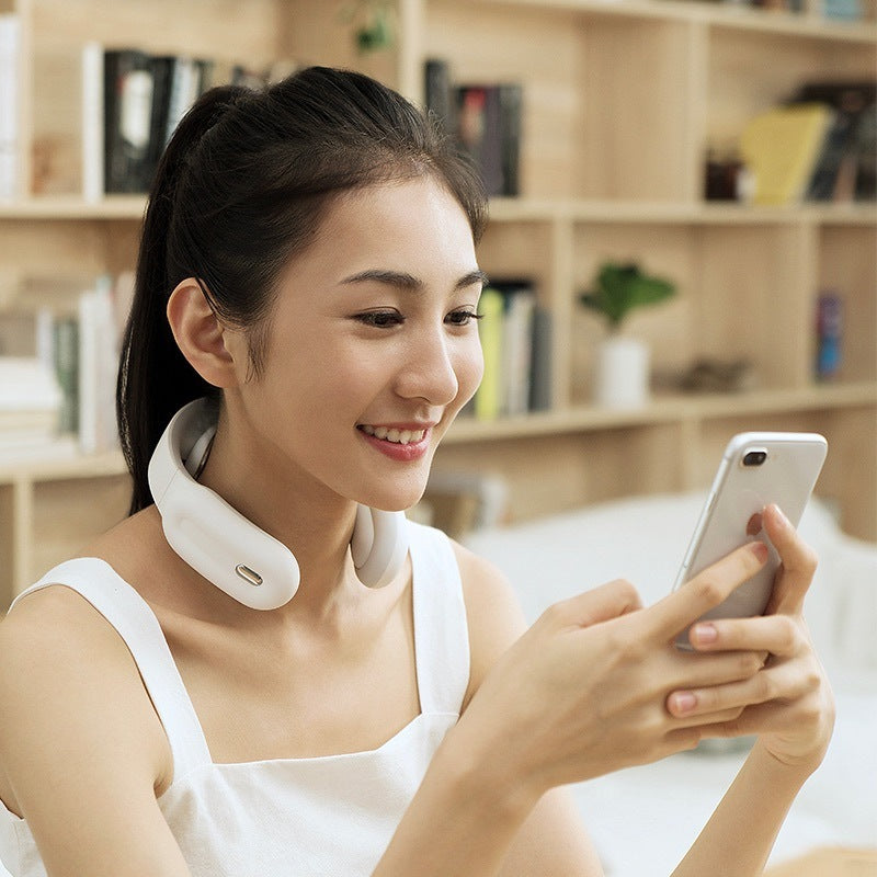 Woman using a smart neck massager device at home 